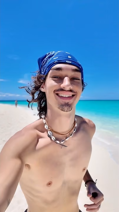 Robert on a white sandbar off Camiguin, turquoise water behind him.