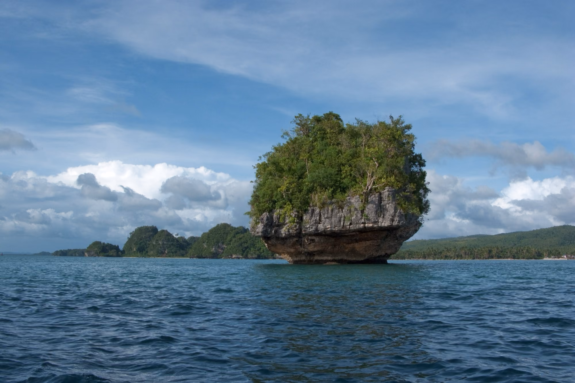 Limestone islands rising from calm water in San Pedro Bay near Marabut, Samar.